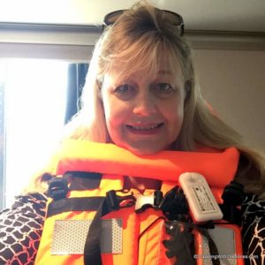 donning life jacket in cabin during emergency drill