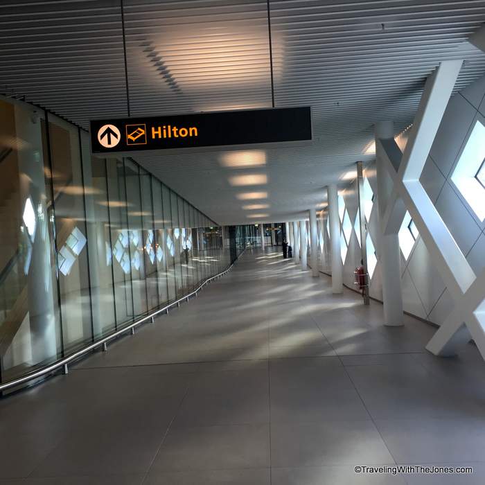Hilton sign from Amsterdam Airport Schiphol directing travelers to Hilton Hotel