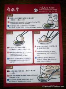 instructions on how to enjoy a soup dumpling at Din Tai Fung in Taipei, Taiwan