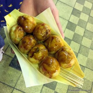 eating takoyaki in Osaka, Japan