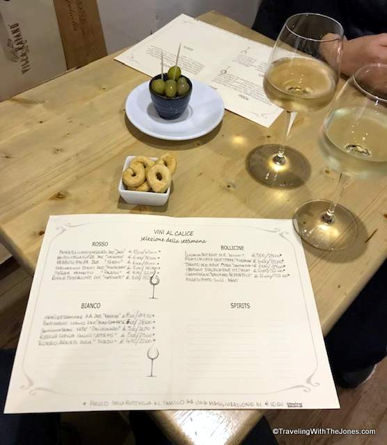 enjoying wine by the glass at Kiarotti wine shop in Rome, Italy